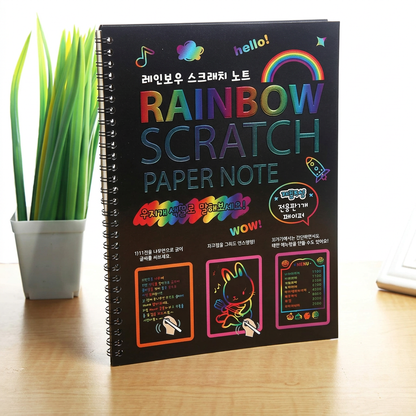 Magic scratch-art book flatlay with stylus and colorful scratched designs