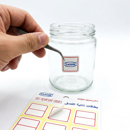Marking a jar with a small Yassin white square self-adhesive label