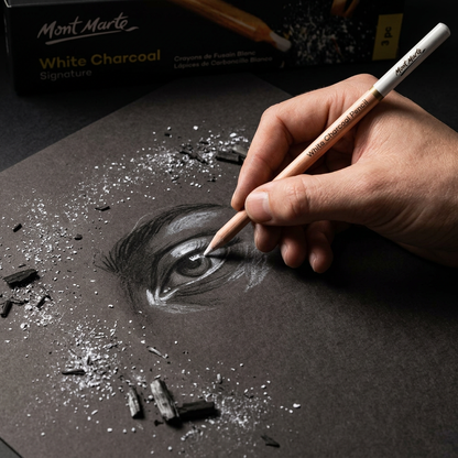 Hand drawing white highlights with a Mont Marte white charcoal pencil on dark paper