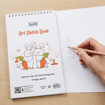 Hand sketching in the open Yassin small white wire-bound sketchbook