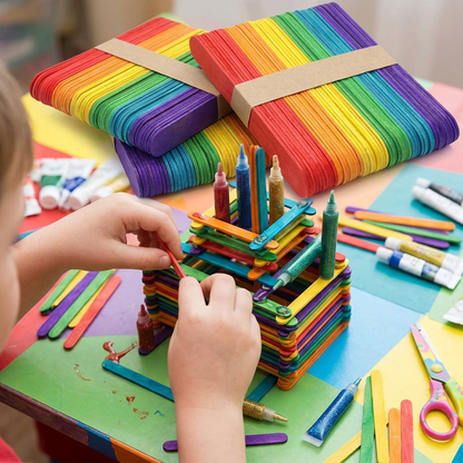 Child building a craft project with wooden ice cream craft sticks