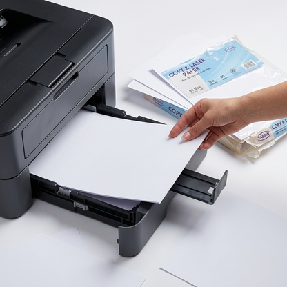 Hand loading Yassin A4 white copy paper into an office printer tray