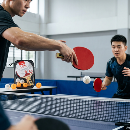 Two people playing table tennis with M&G paddles