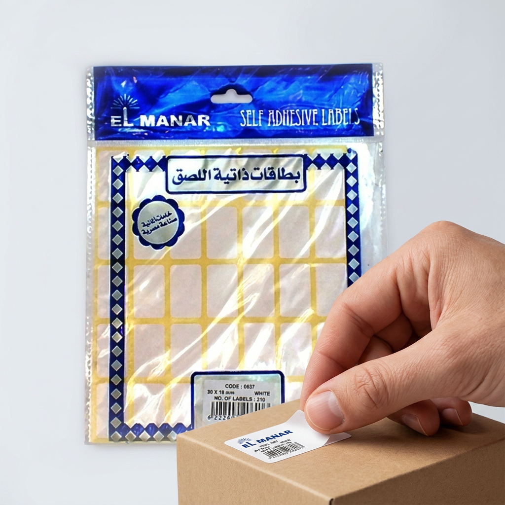 Pricing a product box with a small white El Manar self-adhesive label