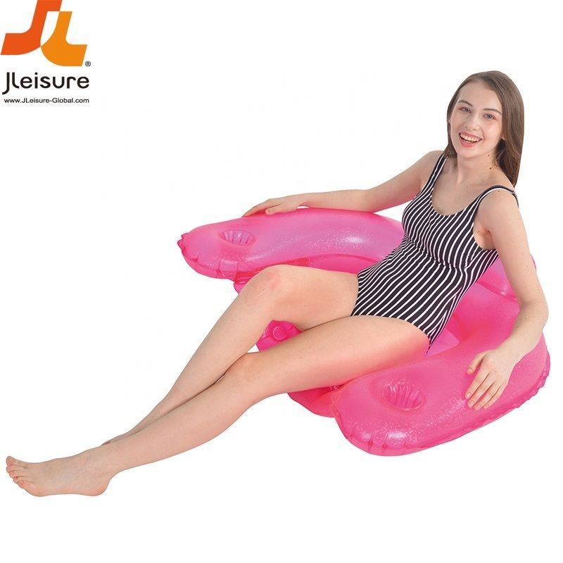 Woman sitting on a pink inflatable pool float with JL Leisure logo.
