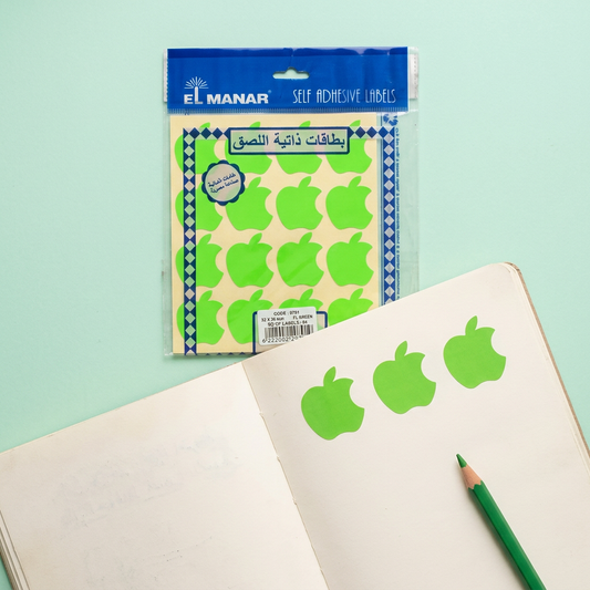 El Manar green apple reward sticker sheet flatlay with peeled stickers
